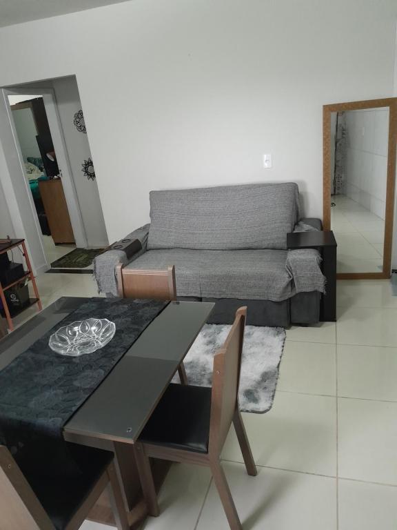 a living room with a table and a couch at Hostel bons sonhos Um Quarto uma Cama de Casal in Penha
