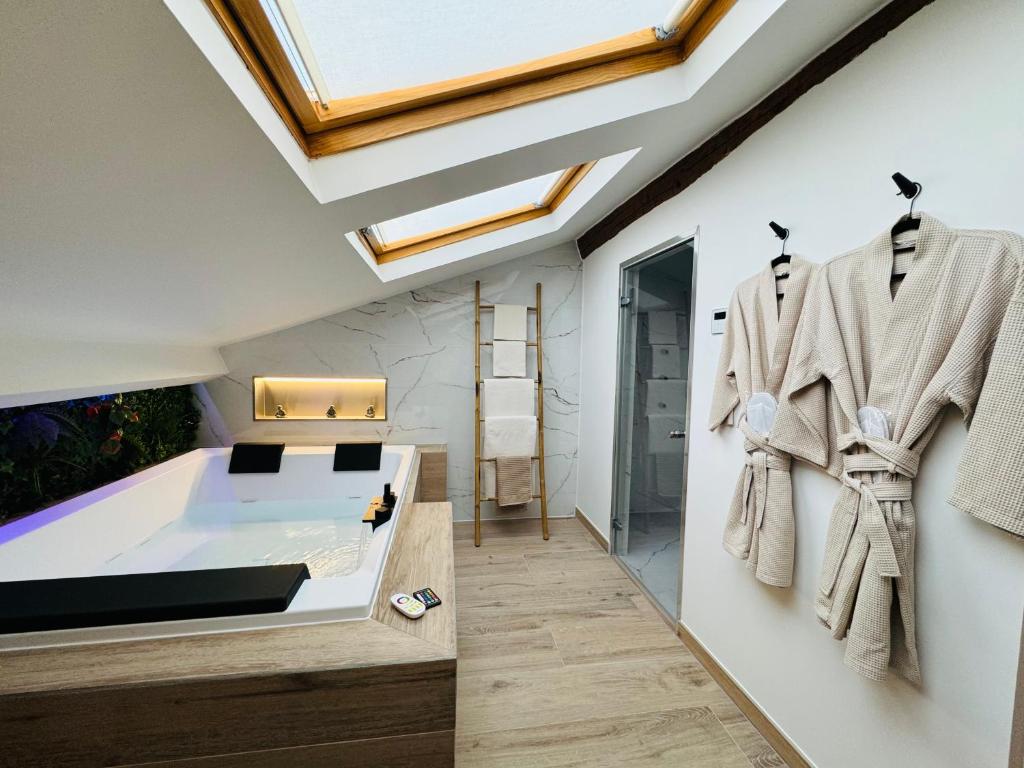 a bedroom with a bathtub and a window at Love & Spa Fréjus in Fréjus