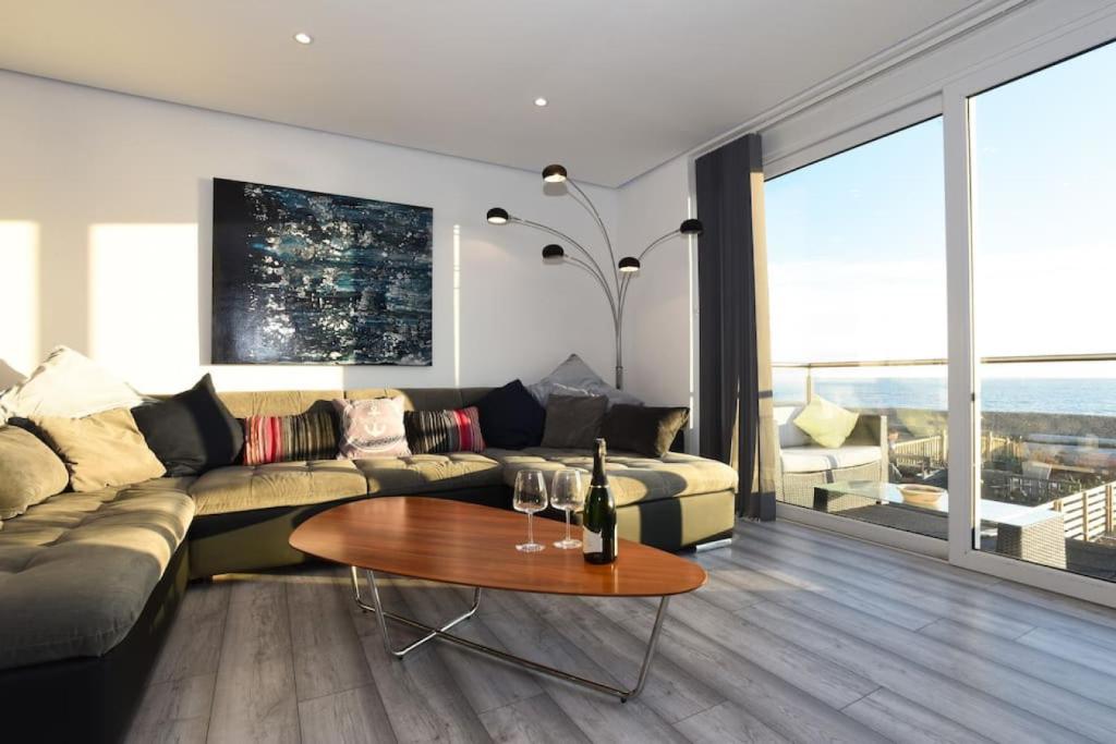 een woonkamer met een bank en een tafel bij Amazing view High end beachfront 3BR 5beds 7 guest in South Hayling