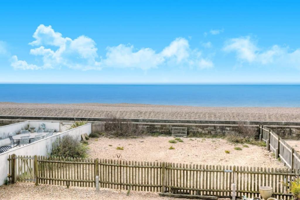 a view of the beach from the balcony of a beach house at Modern 2BR w sea views beach access in South Hayling