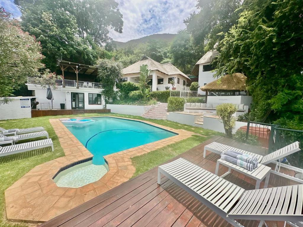 a backyard with a swimming pool and a house at ScenicViews@103 in Hartbeespoort