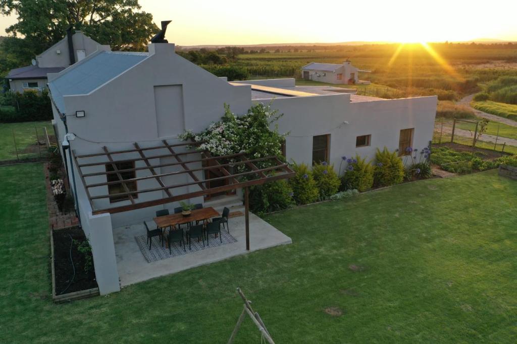 an overhead view of a white house with a table at Lowergroen Guestfarm, Working Farm in Swellendam