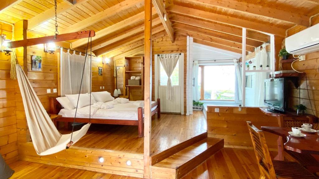 a room with a swing in a log cabin at פינה ברמות - צימרים לנוף הכנרת in Moshav Ramot