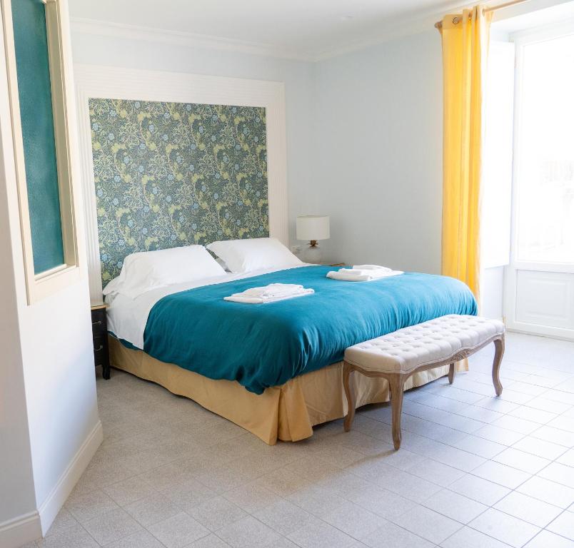 una camera da letto con un grande letto con una coperta blu di Domus Sibyllina, Palazzo Cavalcanti a Napoli
