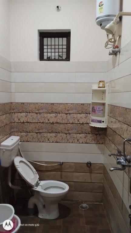 a bathroom with a toilet and a sink at Guru Kripa Guest House ( Home Stay ) in Ayodhya