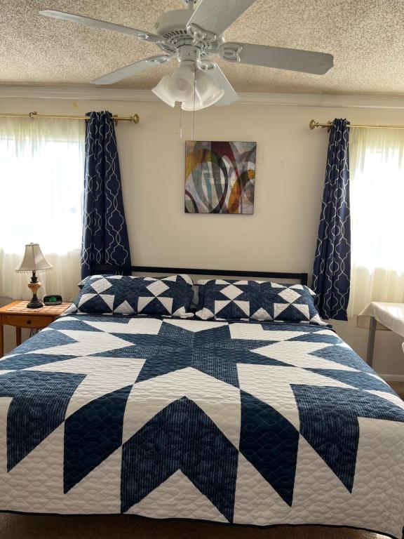a bedroom with a black and white quilt on a bed at Executive Room in North Fort Myers