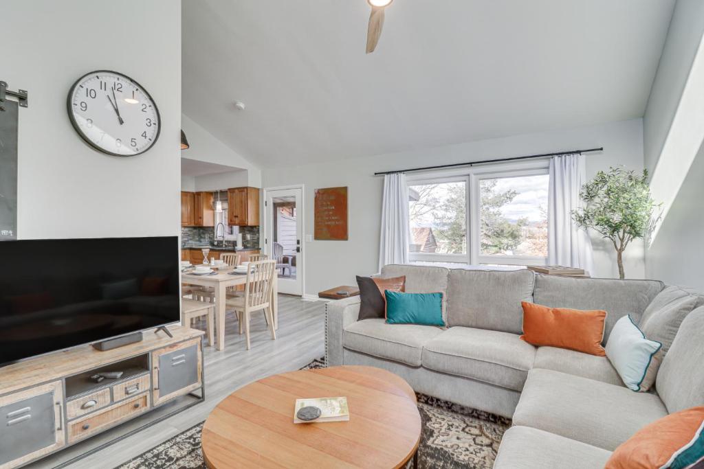 a living room with a couch and a tv at Harrisonburg Home with Deck - 2 Mi to JMU! in Harrisonburg