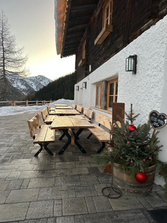 a wooden picnic table in front of a building at Peer Alm in Navis