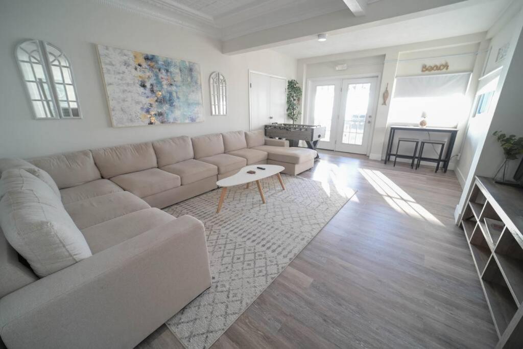a white living room with a couch and a table at The Historic Oneida Lake House - Condo 3 in Blossvale
