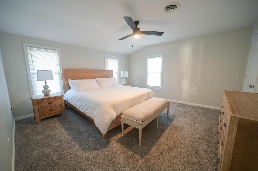 a bedroom with a bed and a ceiling fan at The Historic Oneida Lake House Condo 5 (Penthouse) in Blossvale