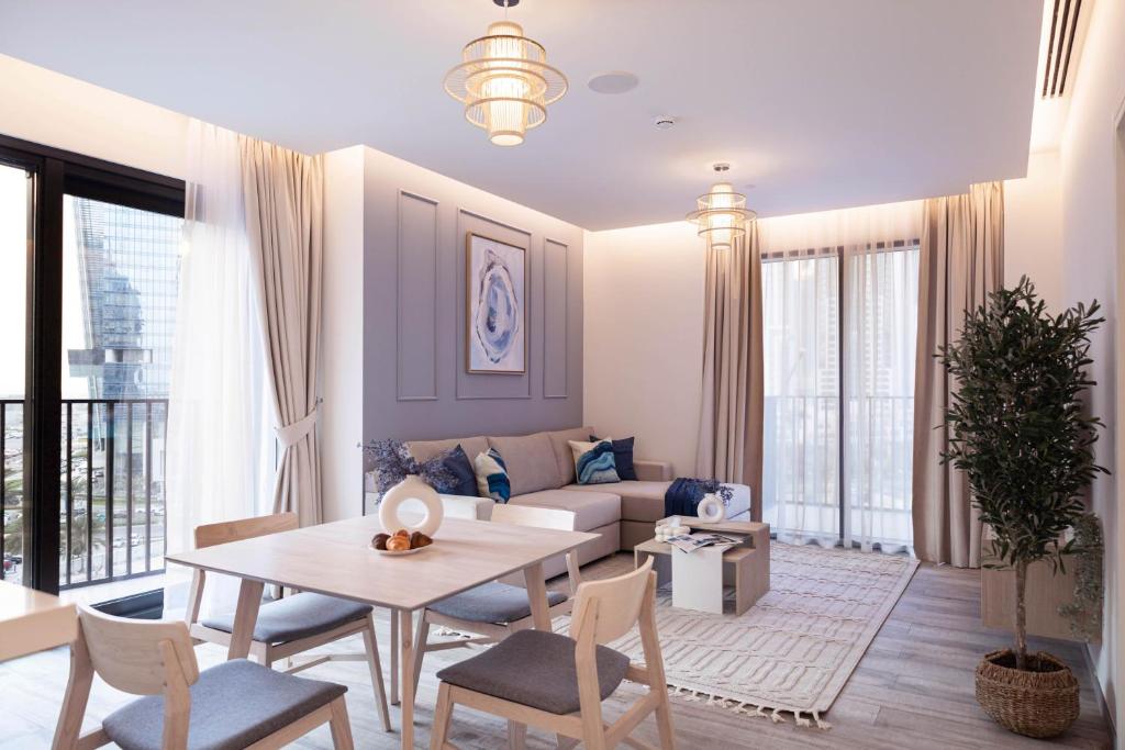 a living room with a table and a couch at Trophy - Ahad Residence Business Bay Suite in Dubai
