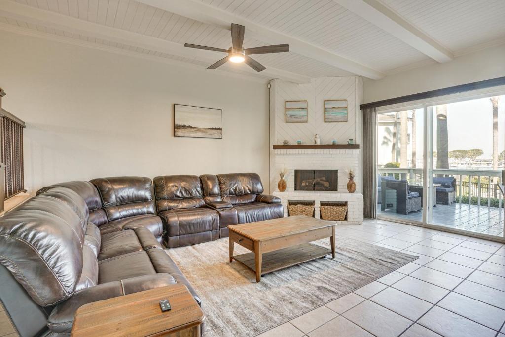 a living room with a leather couch and a table at Huntington Beach Condo - Walk to the Ocean! in Huntington Beach