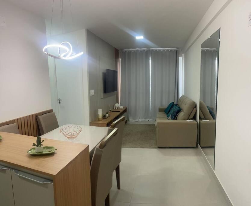 a kitchen and living room with a table and a couch at Apartamento Ponta Verde. Edf. Promenade II in Maceió