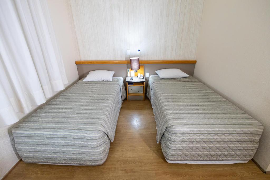 Postel nebo postele na pokoji v ubytování Sables Hotel Guarulhos