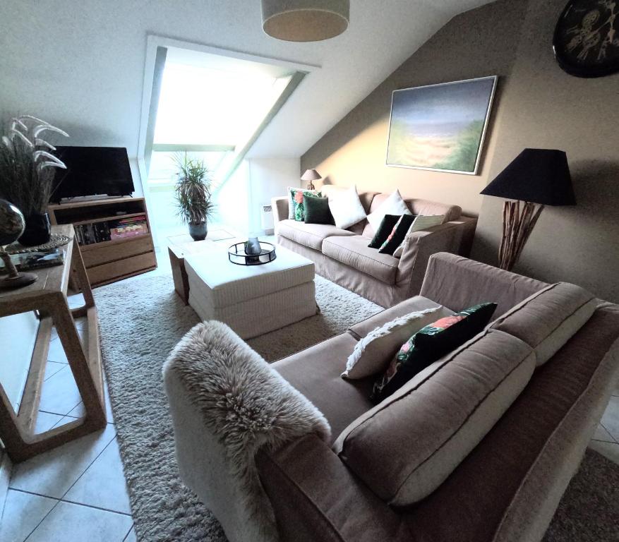 a living room with a couch and a table at Skyview Suite in Oostduinkerke