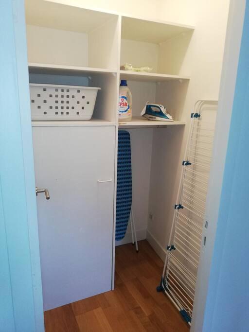 a small closet with white shelves in a room at CAN MAYRA in Perpignan