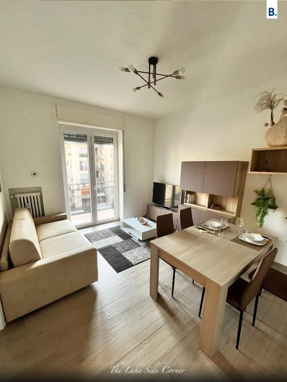 a living room with a table and a couch at [The LaKe-SiDe CorNer] Apartment in Como