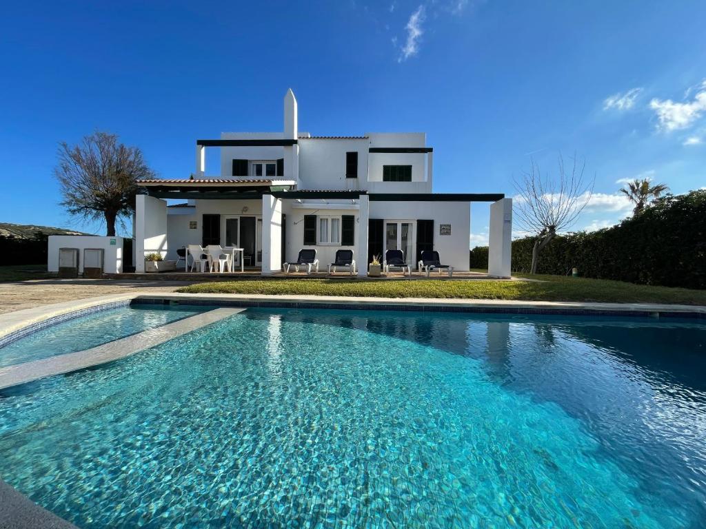 a house with a swimming pool in front of a house at Villa Pont d'En Gil in Cala en Blanes