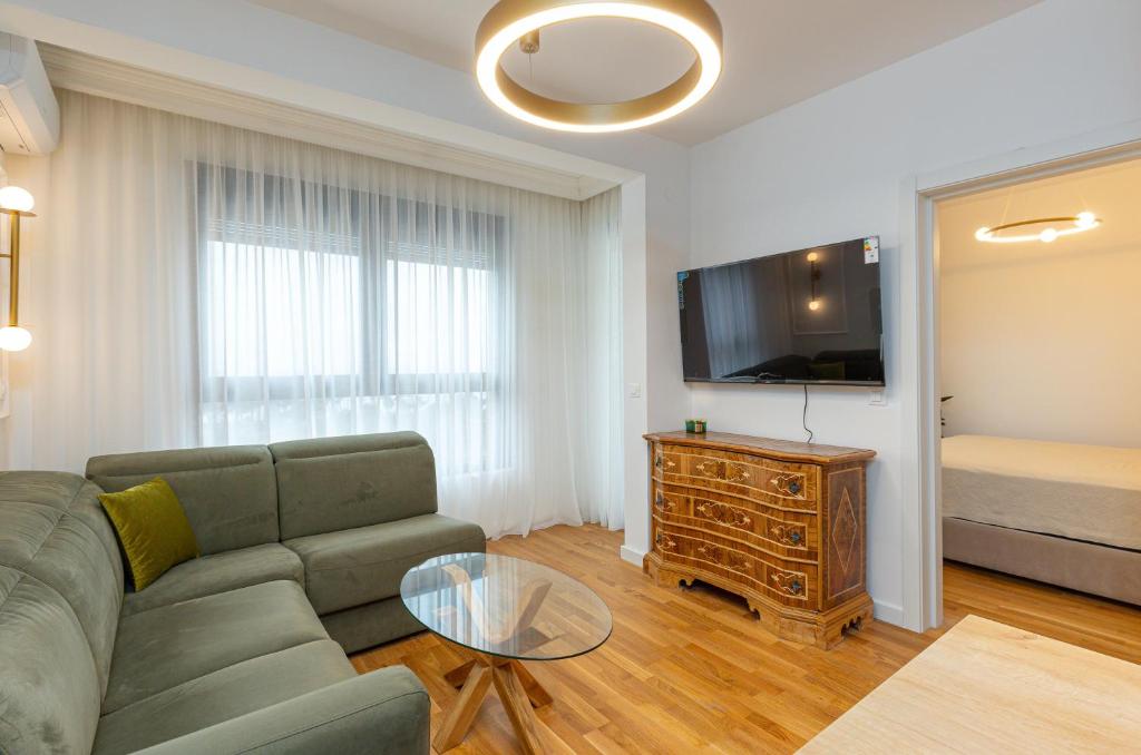 a living room with a couch and a flat screen tv at ADRIATIC VIEW M in Bar