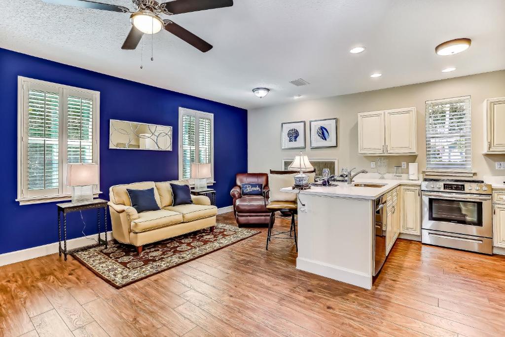 a kitchen and living room with blue walls and a couch at 5422 Leonard Street in Fernandina Beach