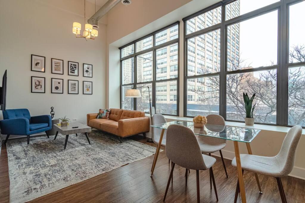 a living room with a glass table and chairs at McCormick Place 420 friendly 3BR/2BA with optional Parking for up to 8 guests in Chicago