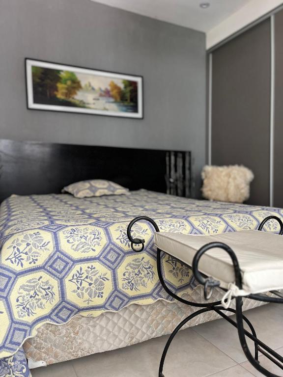 a bedroom with a bed with a chair in it at Bonita Pampa in Santa Rosa