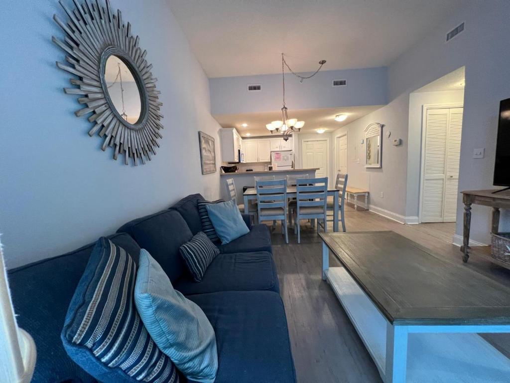 sala de estar con sofá azul y mesa en 2501 S Ocean Blvd, 1215 - Ocean View Sleeps 8, en Myrtle Beach