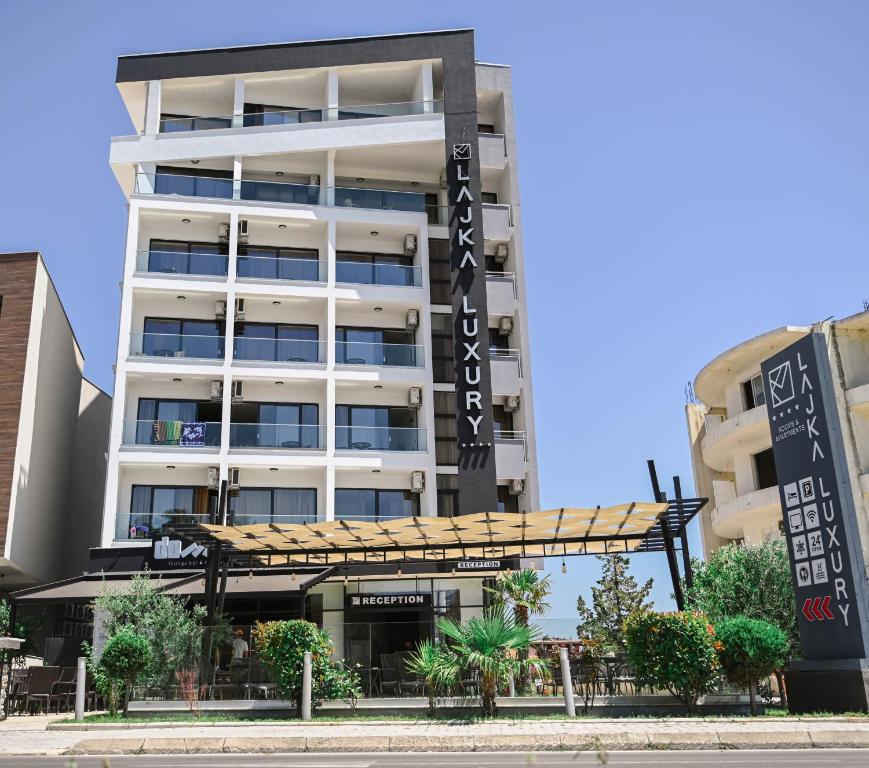 a building with a sign for a hotel at Hotel Lajka Luxury in Ulcinj