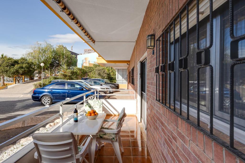 a balcony with a table and chairs on a building at Europa Club Apartment, La Cala de Finestrat, Benidorm, Next to the beach, Ground floor, Air Cond in Benidorm