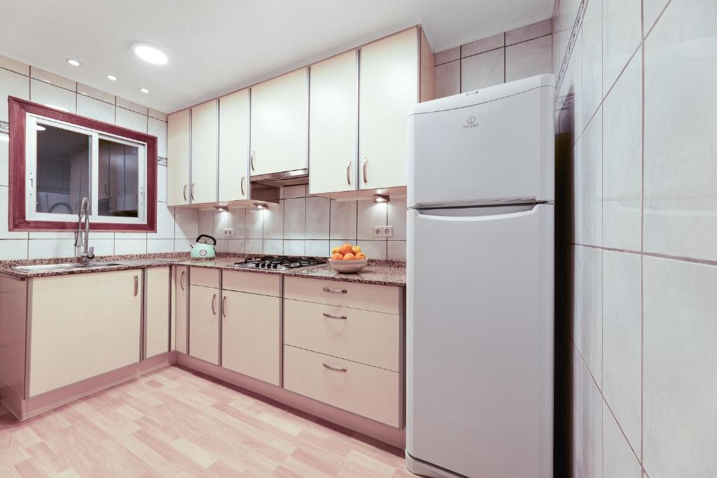 a kitchen with white cabinets and a refrigerator at Europa Club Apartment, La Cala de Finestrat, Benidorm, Next to the beach, Ground floor, Air Cond in Benidorm