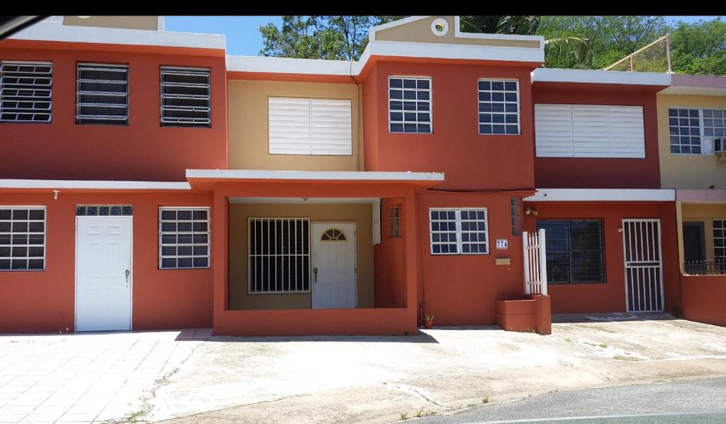 una casa roja y amarilla con entrada en San Juan apartments new en San Juan