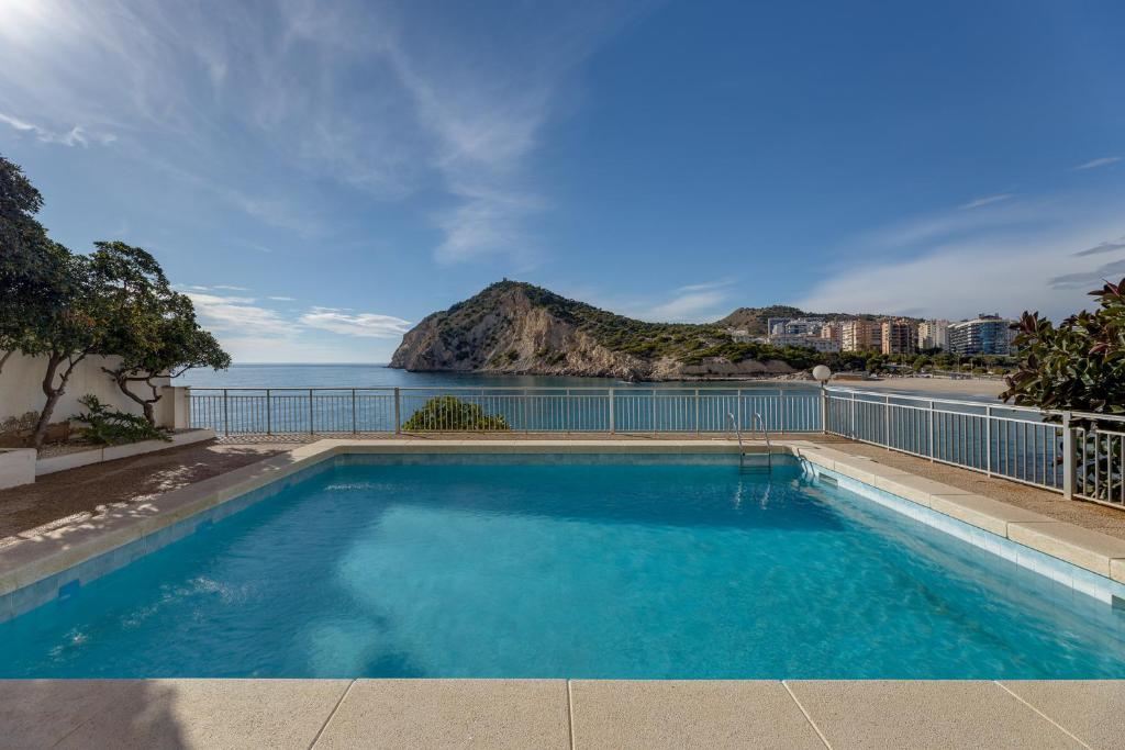 a swimming pool with a view of the ocean at Europa Club Apartment, La Cala de Finestrat, Benidorm, Next to the beach, Ground floor, Air Cond in Benidorm
