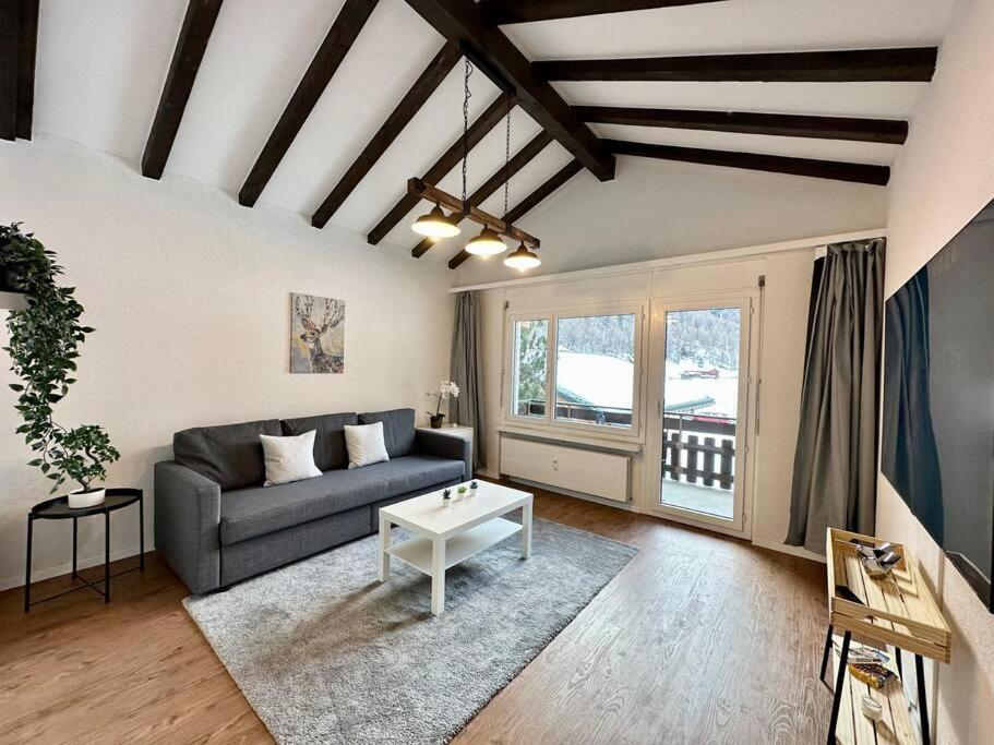a living room with a couch and a table at Panorama apartment for 4 near Zermatt in Täsch