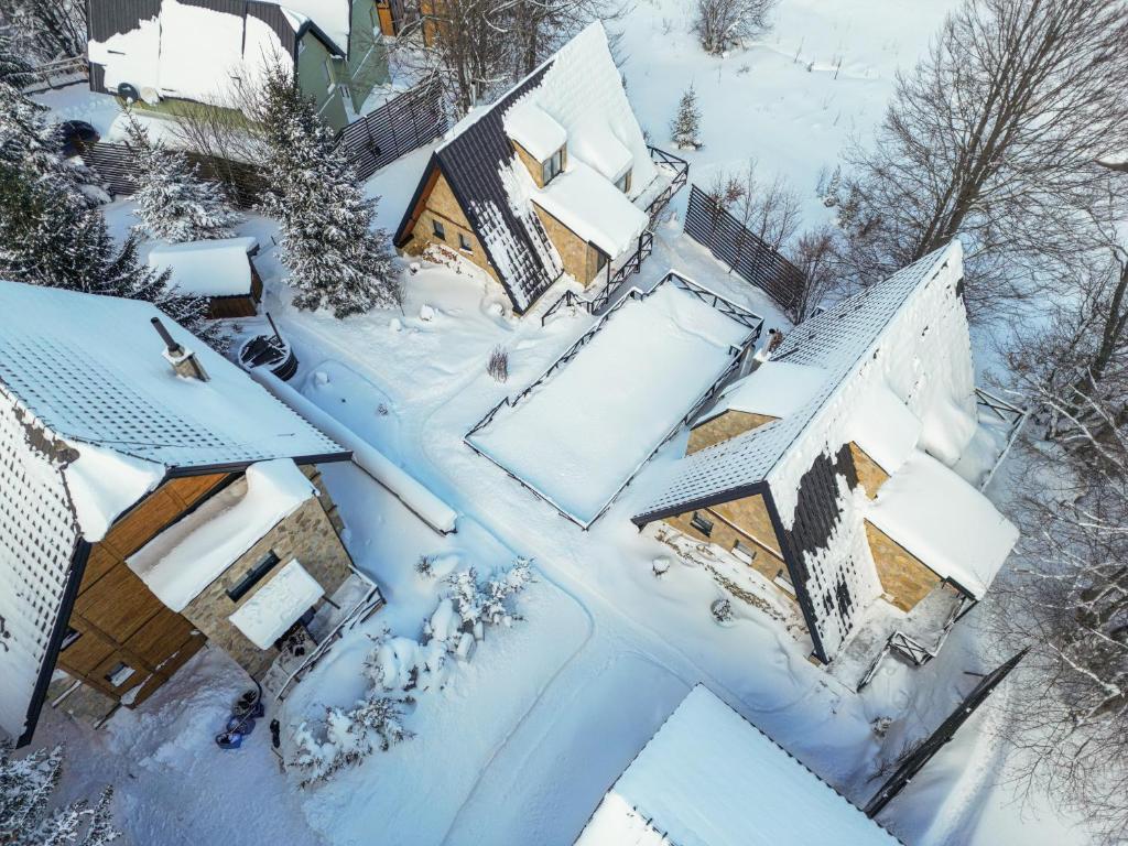 an aerial view of a house covered in snow at Kežman Mountain Houses in Kopaonik