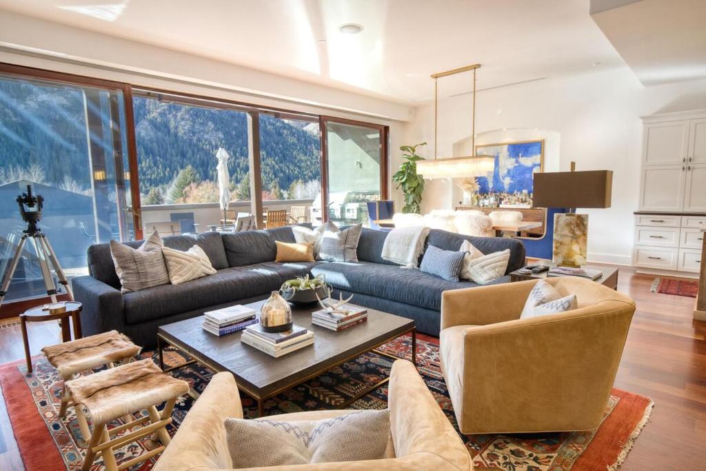 a living room with a couch and a table at Luxe Ketchum Penthouse with Rooftop Hot Tub in Ketchum