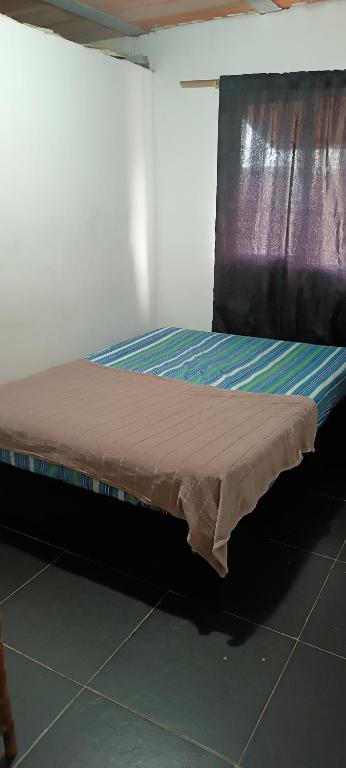 a bed sitting in a room with a mattressvisor at Edificio Lozano 2H in Cali