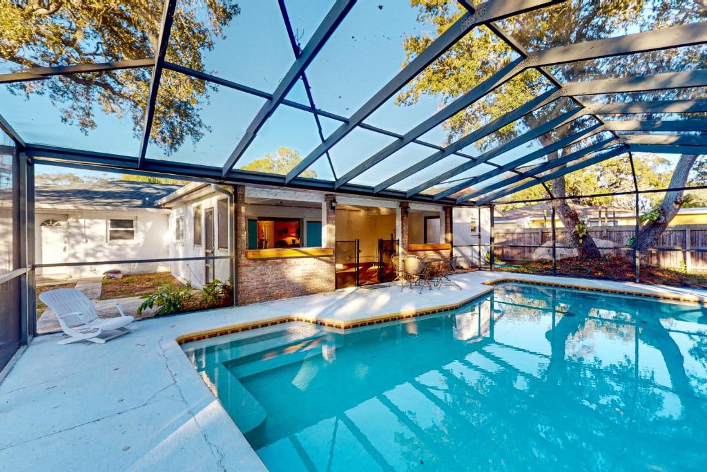 an indoor swimming pool with a glass roof at Aqua Parrot in Largo