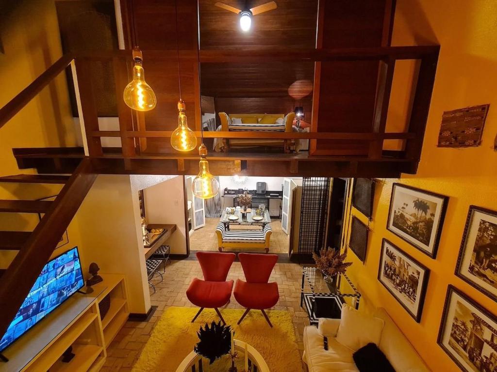an overhead view of a living room with red chairs at Casas Park Way in Brasilia