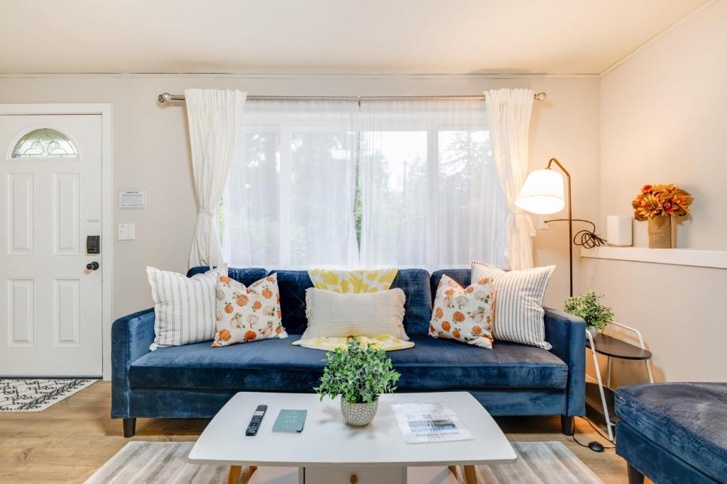 a blue couch in a living room with a window at Eastgate Rambler BY Betterstay in Bellevue