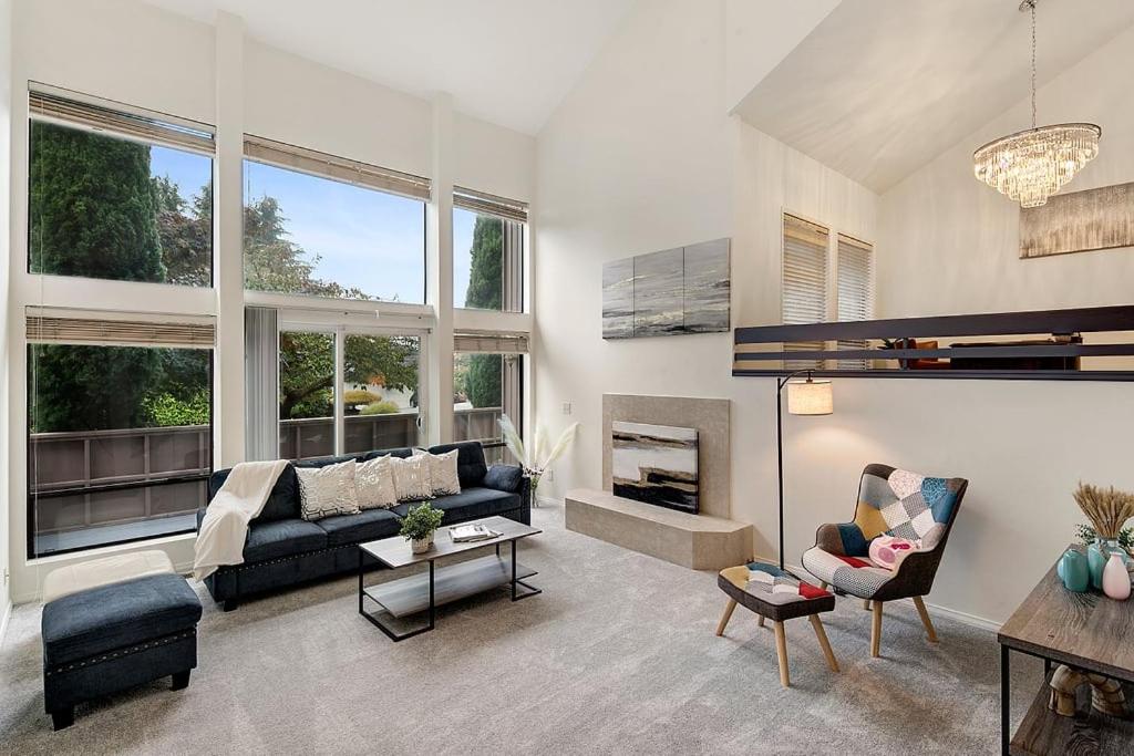 a living room with a couch and a fireplace at Highland Haven BY Betterstay in Bellevue