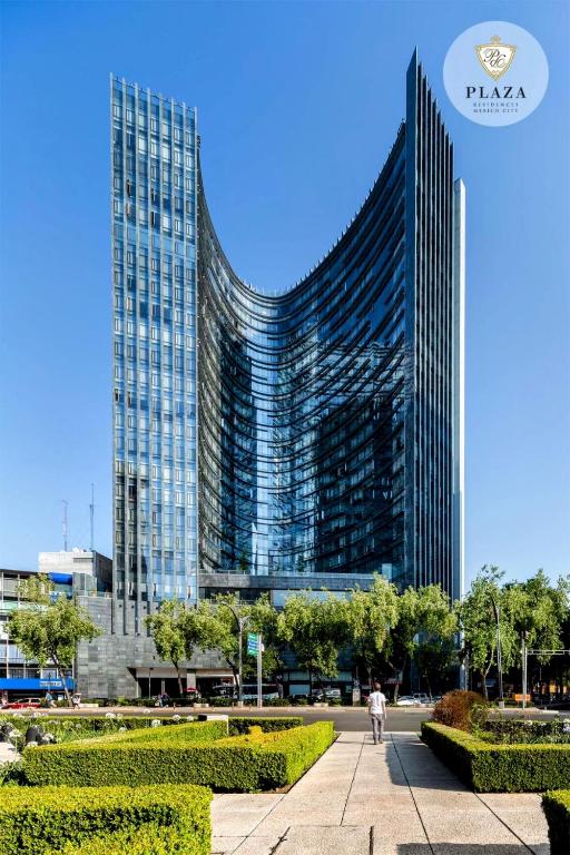 a tall building with a man walking in front of it at AMAZING REFORMA APARTMENT, 2 brms 2 bath, AWESOME in Mexico City