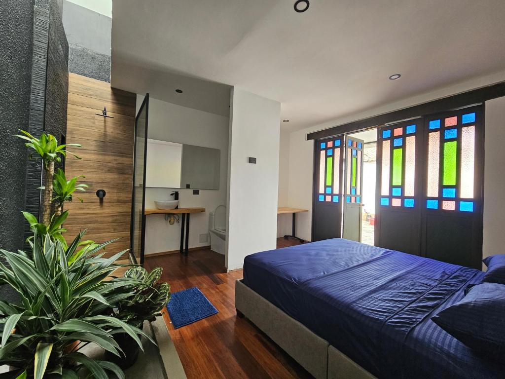 a bedroom with a bed and stained glass windows at Casa Alba in Cali