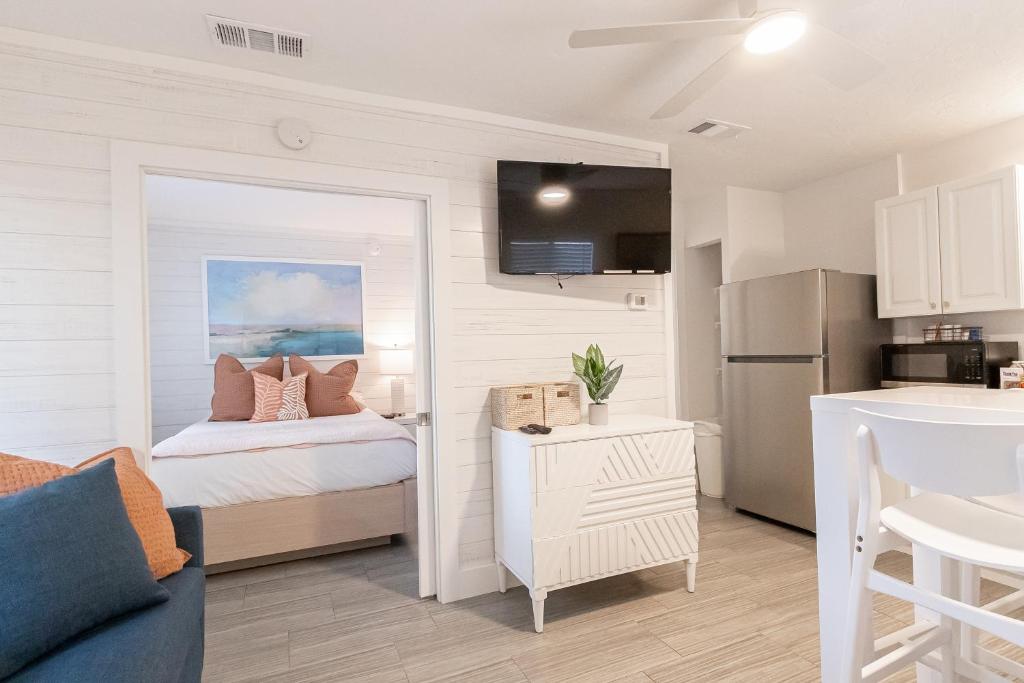 a living room with a bed and a kitchen at Siesta Key Beachside Villas in Sarasota