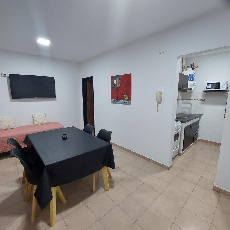 a living room with a table and a kitchen at Departamento Falucho 2 in Santa Rosa