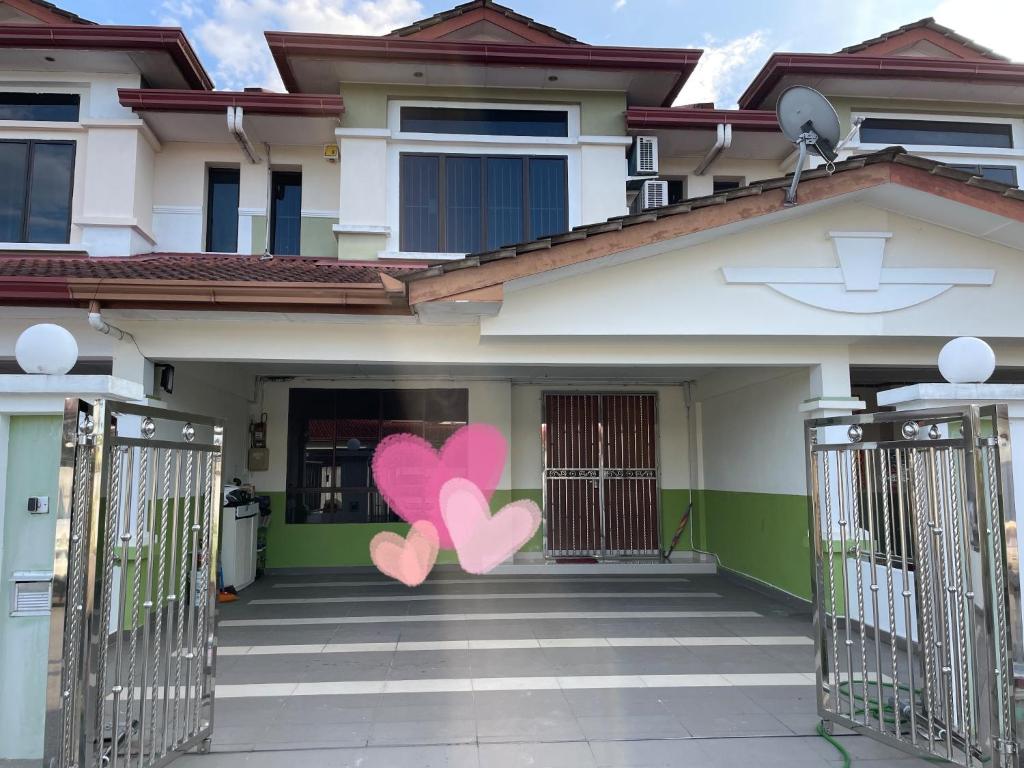 a house with two pink hearts painted on it at Sibu Homestay Happy Family in Sibu
