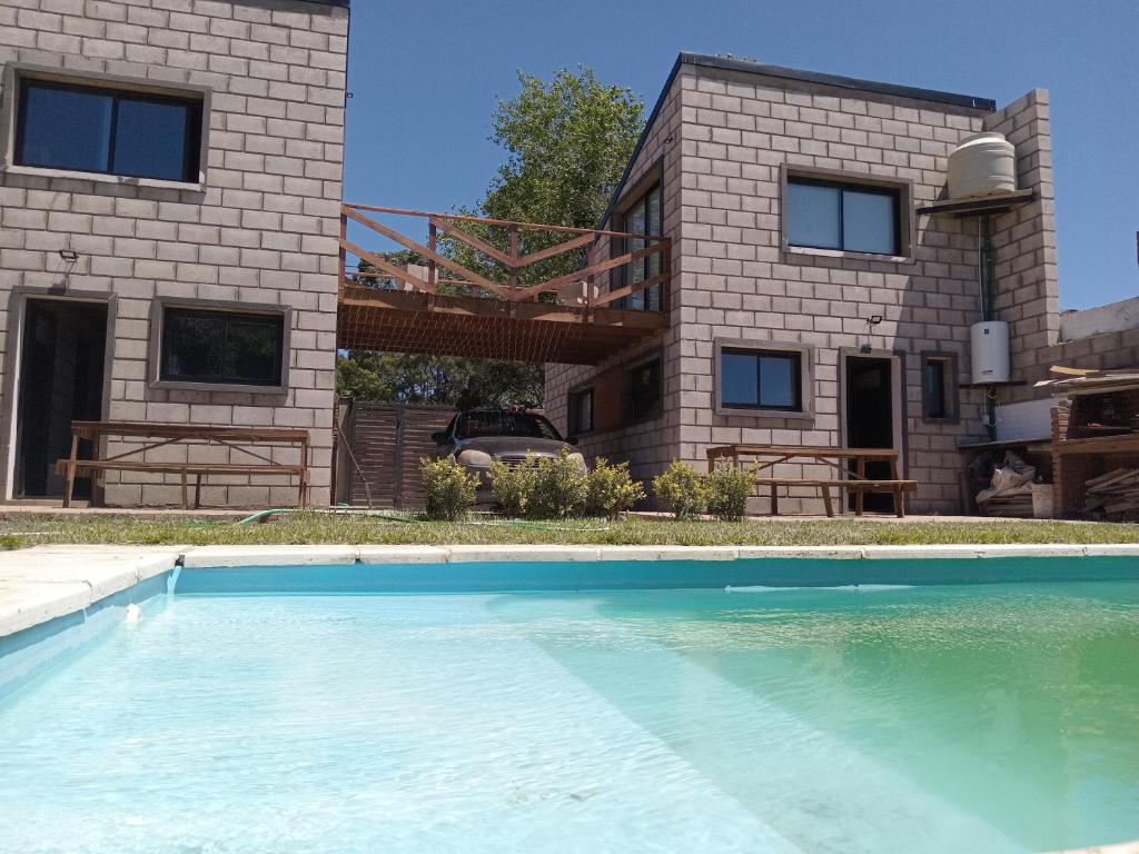 a house with a swimming pool in front of a house at LOS ALTOS DE SAN JACINTO 2 in Mar del Plata