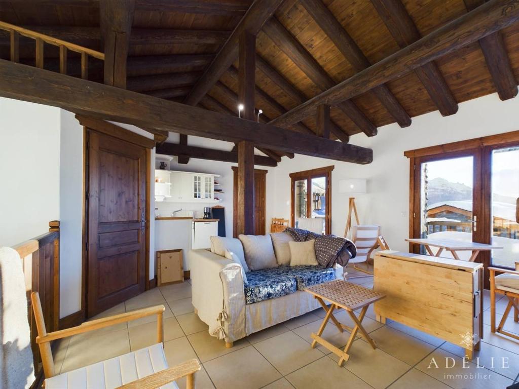 a living room with a couch and a table at Appartement Montvalezan-La Rosière, 3 pièces, 6 personnes - FR-1-398-661 in Montvalezan