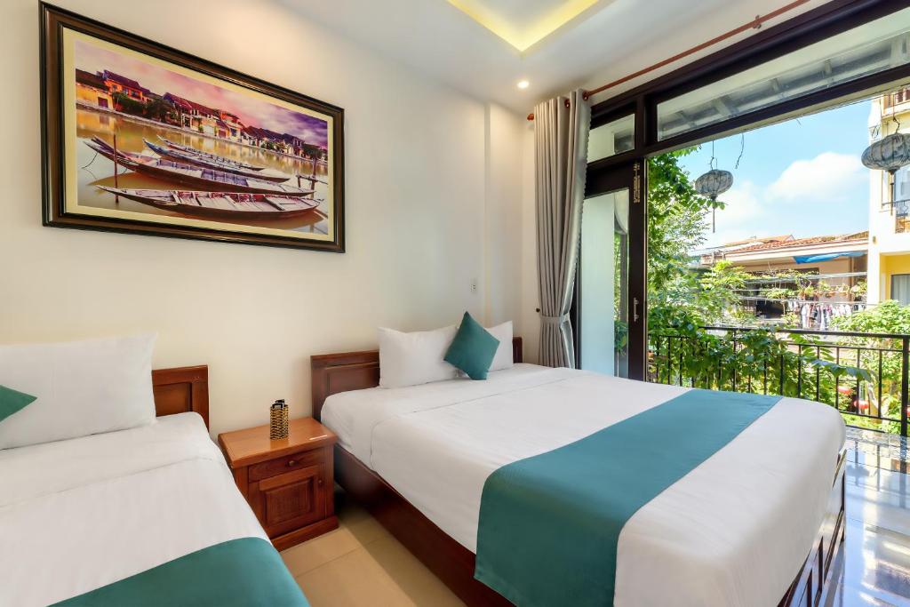 Postel nebo postele na pokoji v ubytování Rockmouse Centre River Villa Hoi An