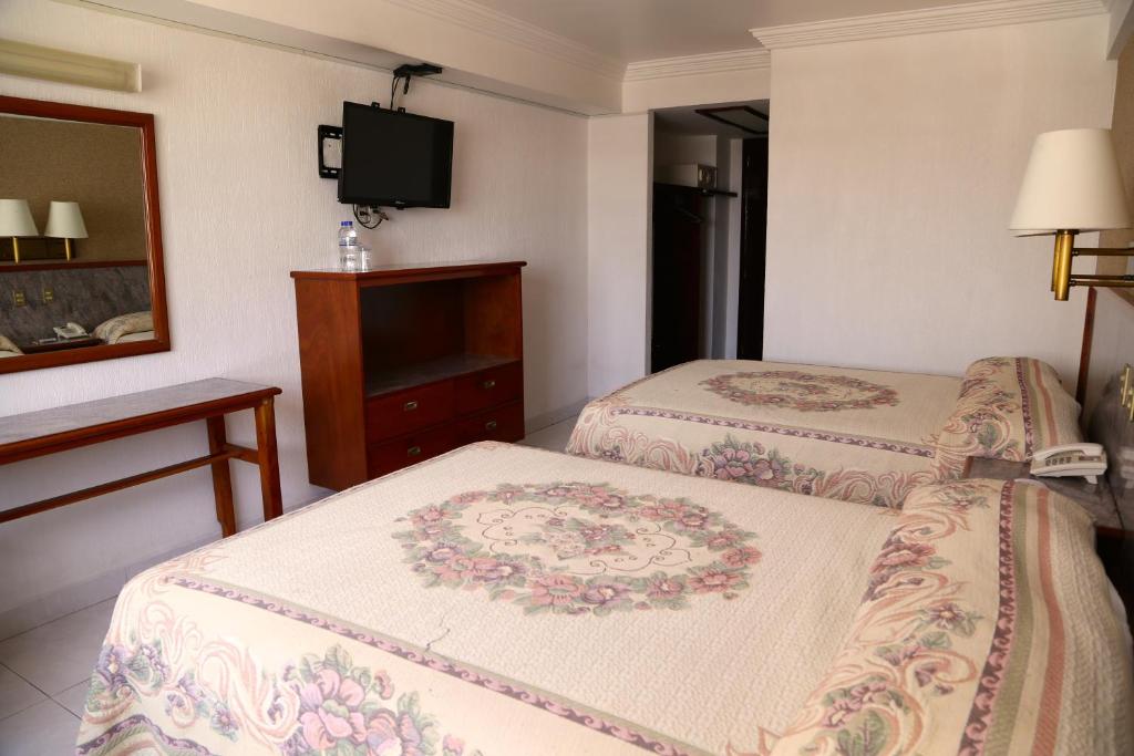 Postel nebo postele na pokoji v ubytování Hotel Baluarte