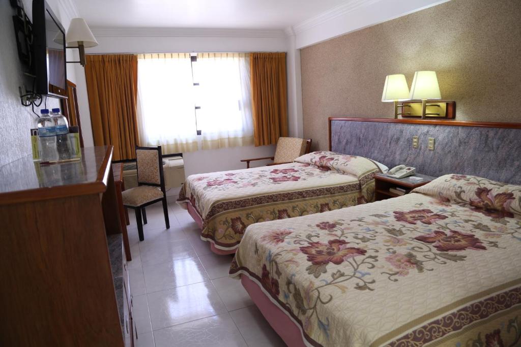 Postel nebo postele na pokoji v ubytování Hotel Baluarte